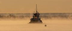 Tug Boat in Morning Sea Smoke